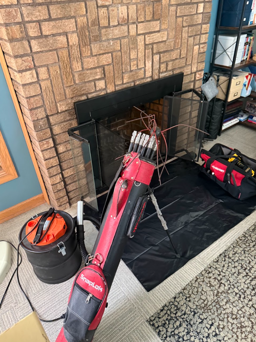 Chimney sweep rods, HEPA vacuum and drop cloth set up at a Cincinnati fireplace