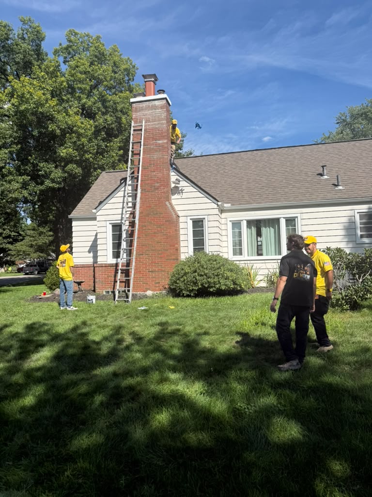 American Chimney & Masonry crew on site at a Cincinnati home with a ladder against the chimney